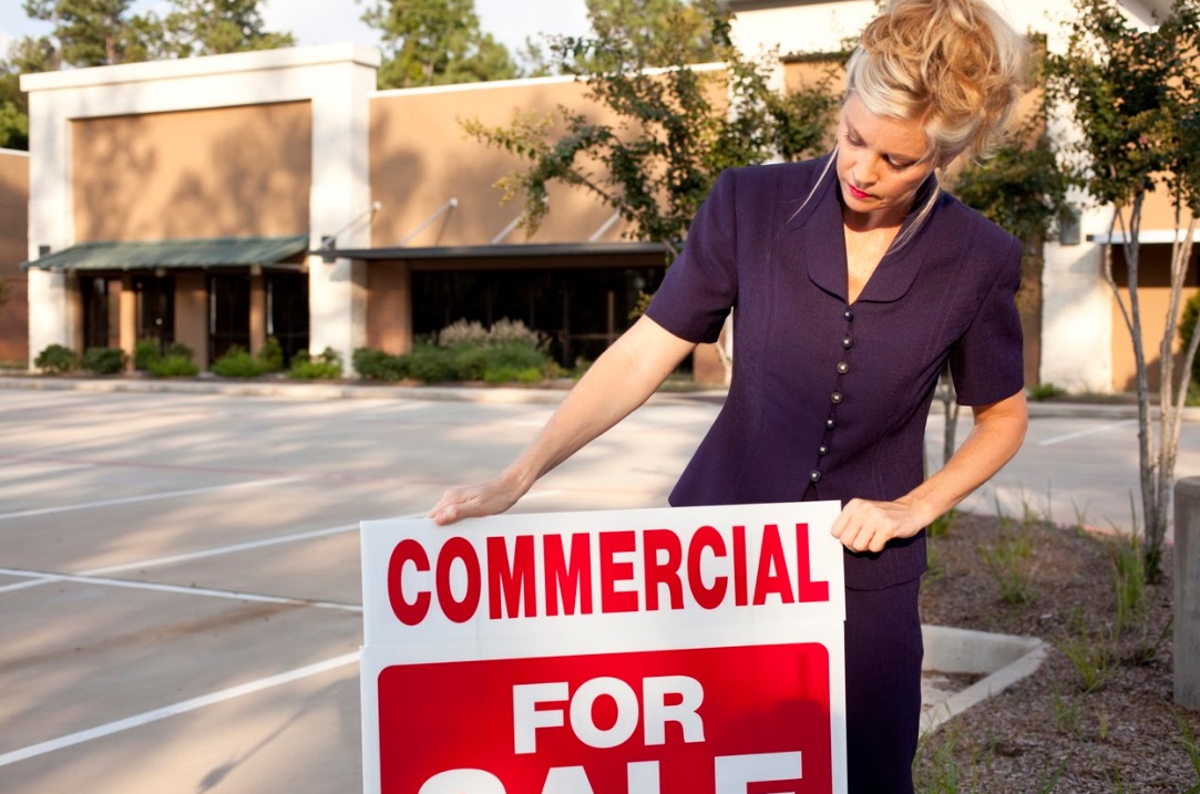 Girl with BillBoard of Commercial sale | BergerBriggs